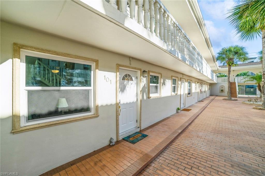 980 7th Avenue South, Unit 101 Naples, FL 34102 - Photo 18 of 32 a view of a building from a porch