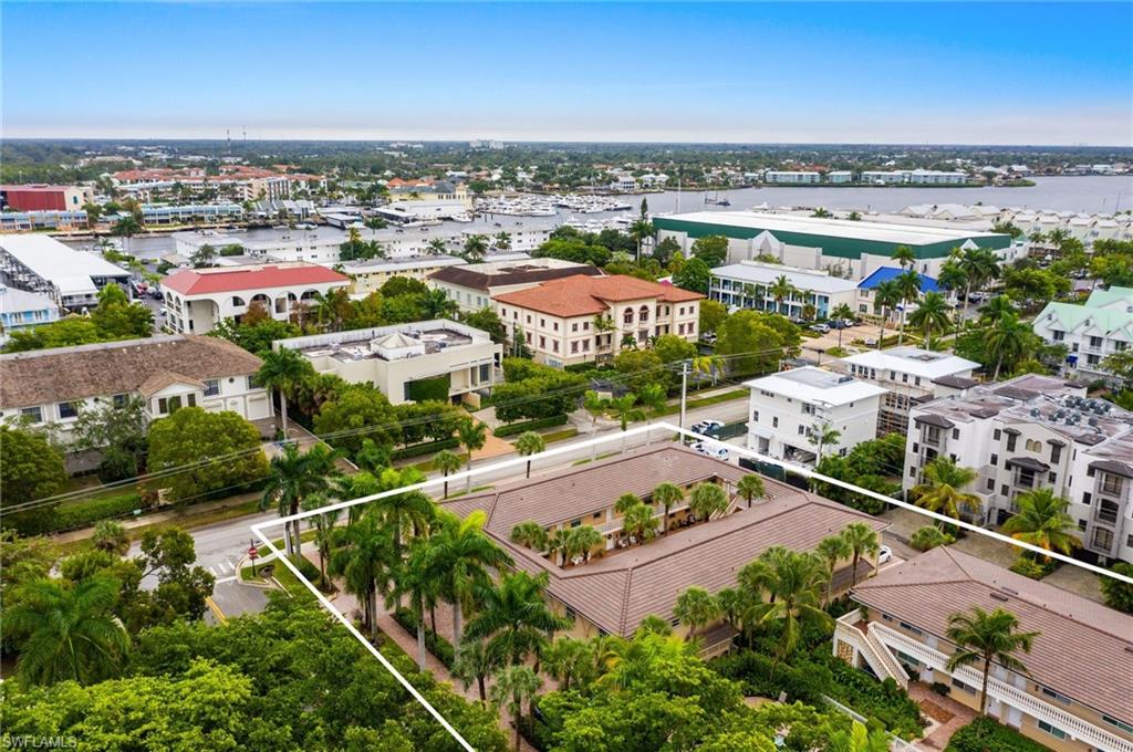 980 7th Avenue South, Unit 101 Naples, FL 34102 - Photo 2 of 32 an aerial view of residential houses with outdoor space