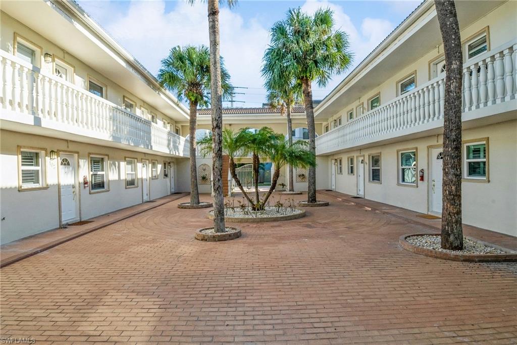980 7th Avenue South, Unit 101 Naples, FL 34102 - Photo 20 of 32 a view of a building with wooden floor and a outdoor space