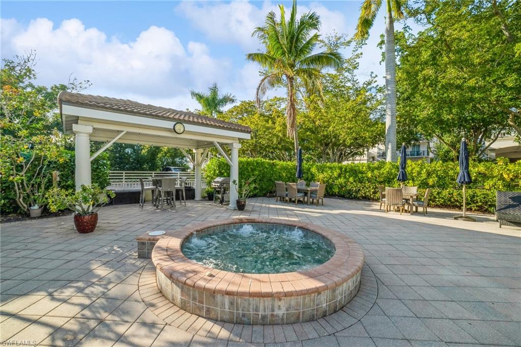 980 7th Avenue South, Unit 101 Naples, FL 34102 - Photo 22 of 32 a view of a swimming pool with a patio