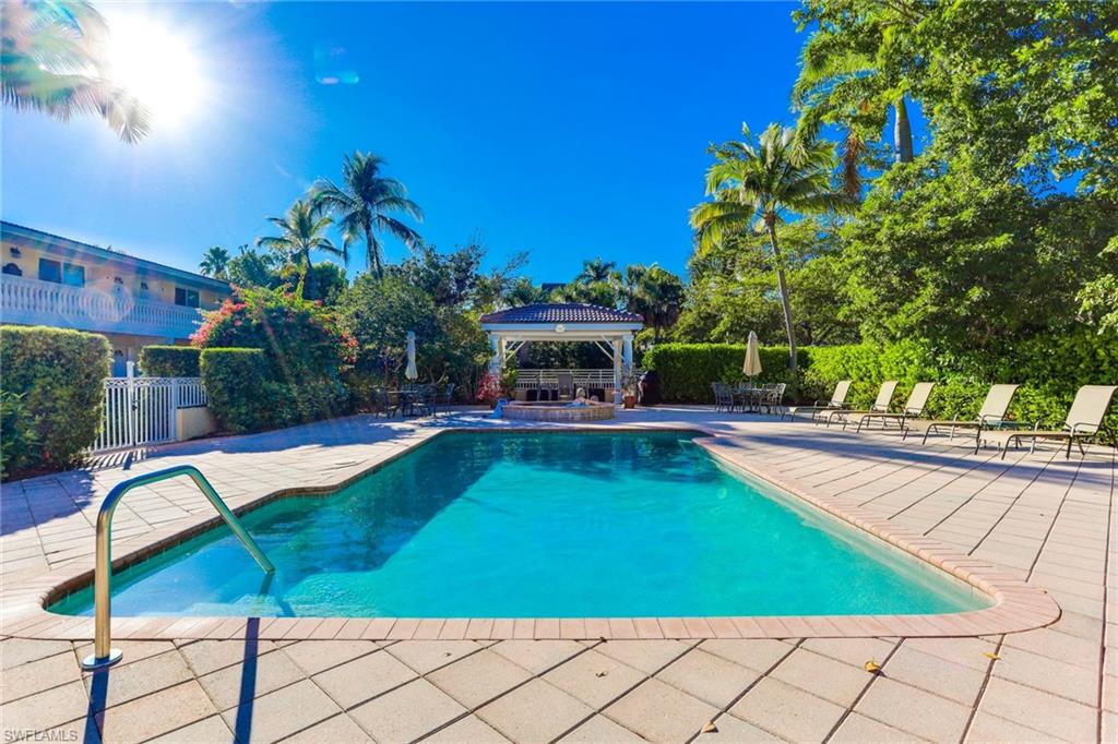 980 7th Avenue South, Unit 101 Naples, FL 34102 - Photo 29 of 32 a view of a swimming pool with a patio