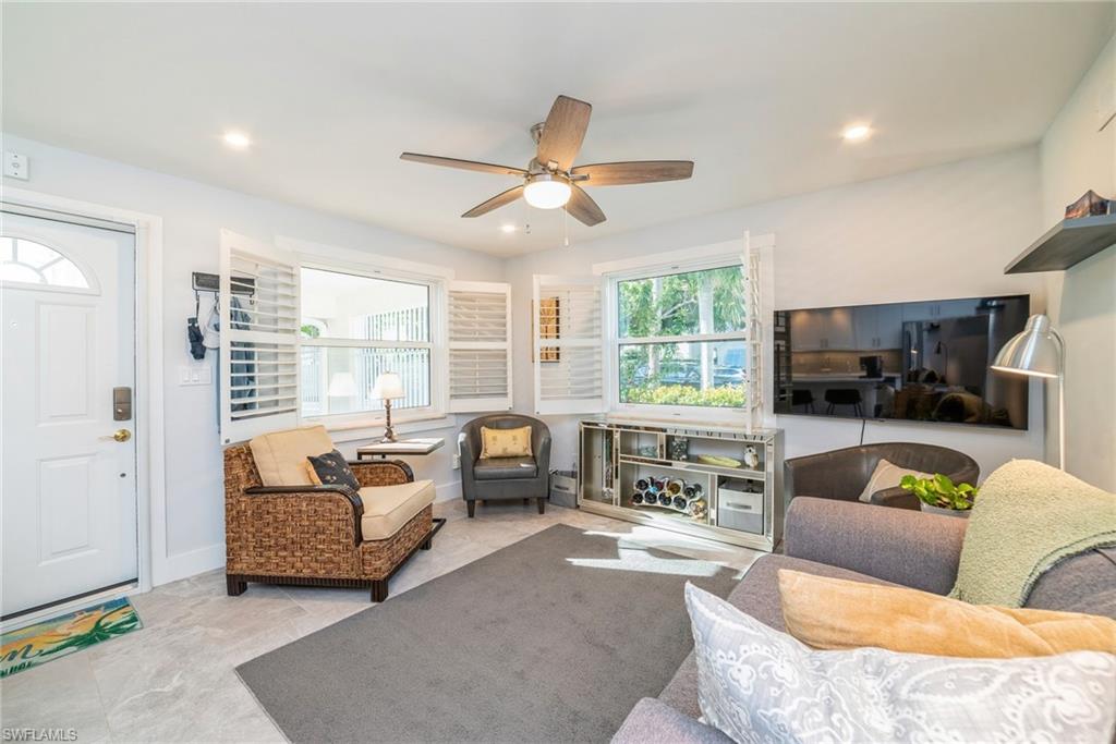 980 7th Avenue South, Unit 101 Naples, FL 34102 - Photo 5 of 32 a living room with furniture and a large window