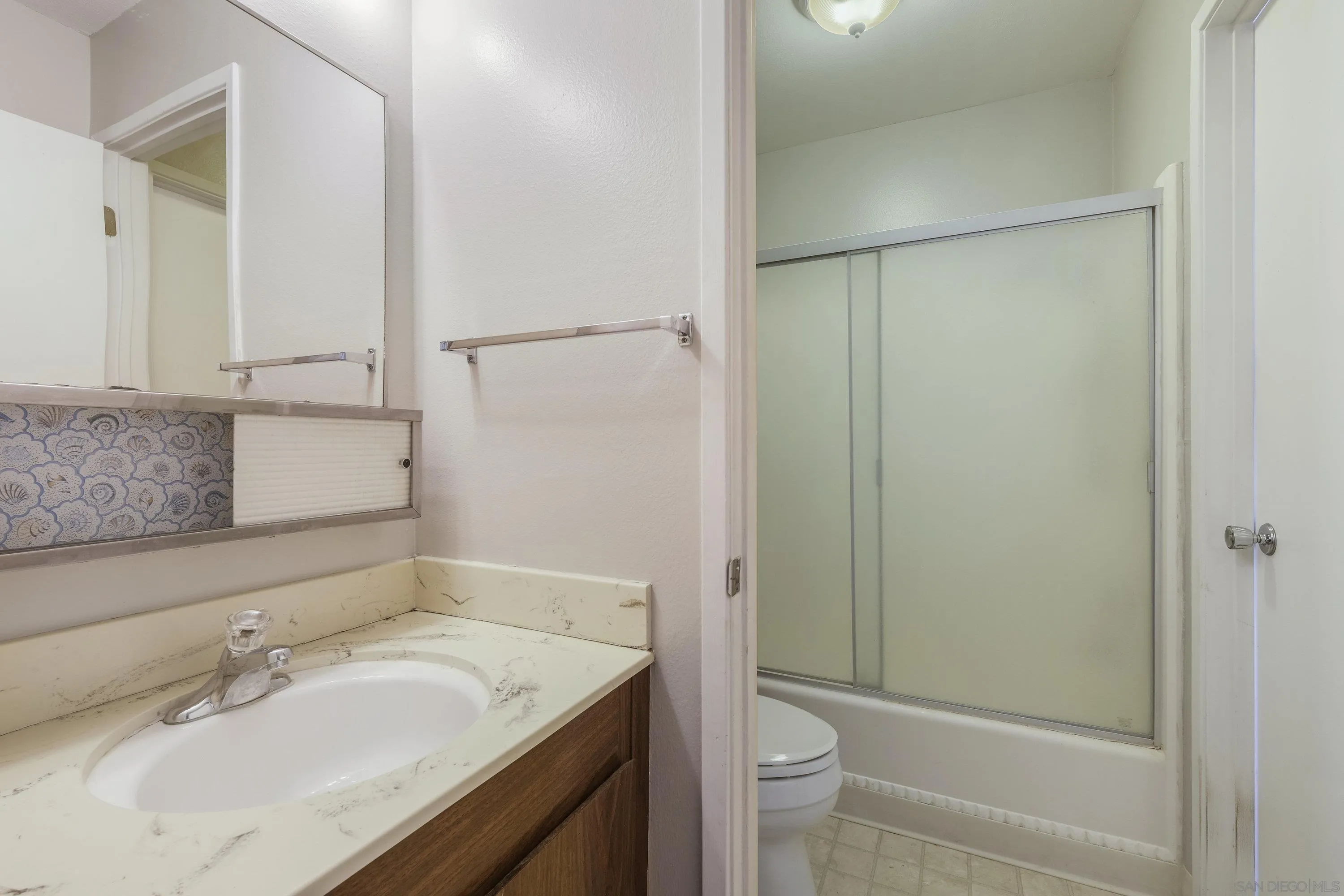 379 Eldridge Avenue Vacaville, CA 95688 - Photo 13 of 19 a bathroom with a granite countertop sink toilet and shower