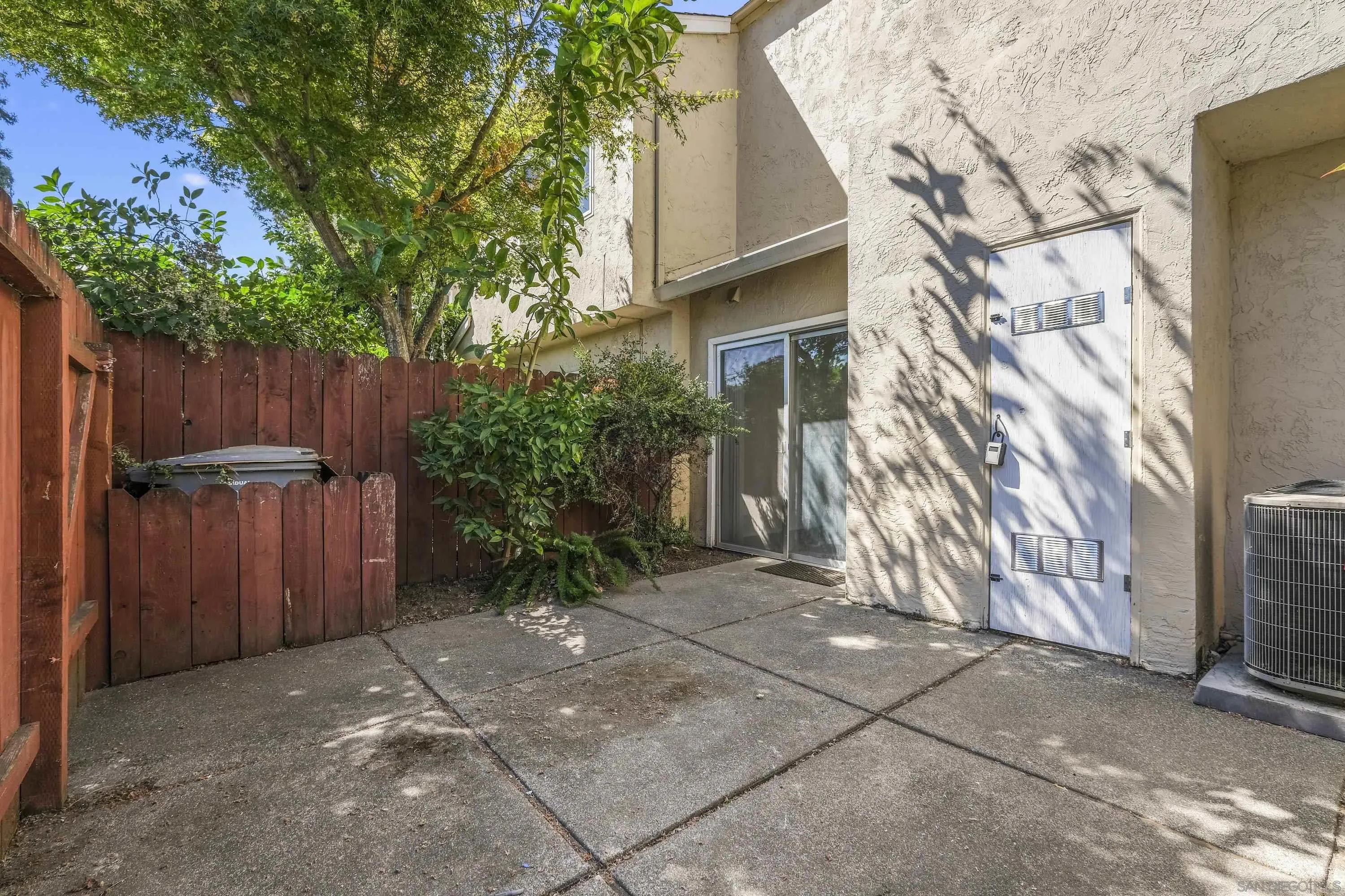 379 Eldridge Avenue Vacaville, CA 95688 - Photo 17 of 19 a view of backyard with potted plants and wooden fence