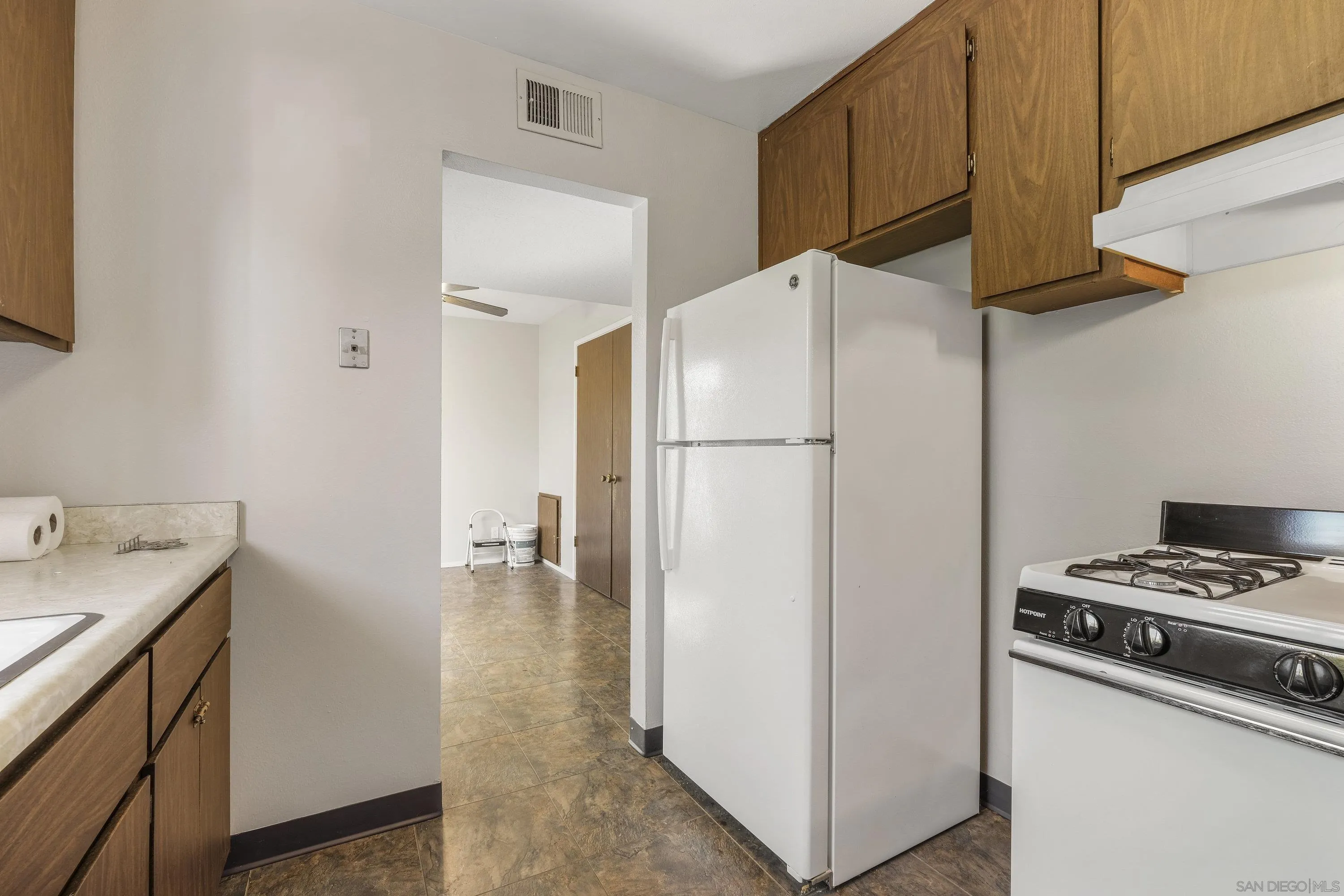 379 Eldridge Avenue Vacaville, CA 95688 - Photo 8 of 19 a kitchen with a refrigerator and a stove top oven