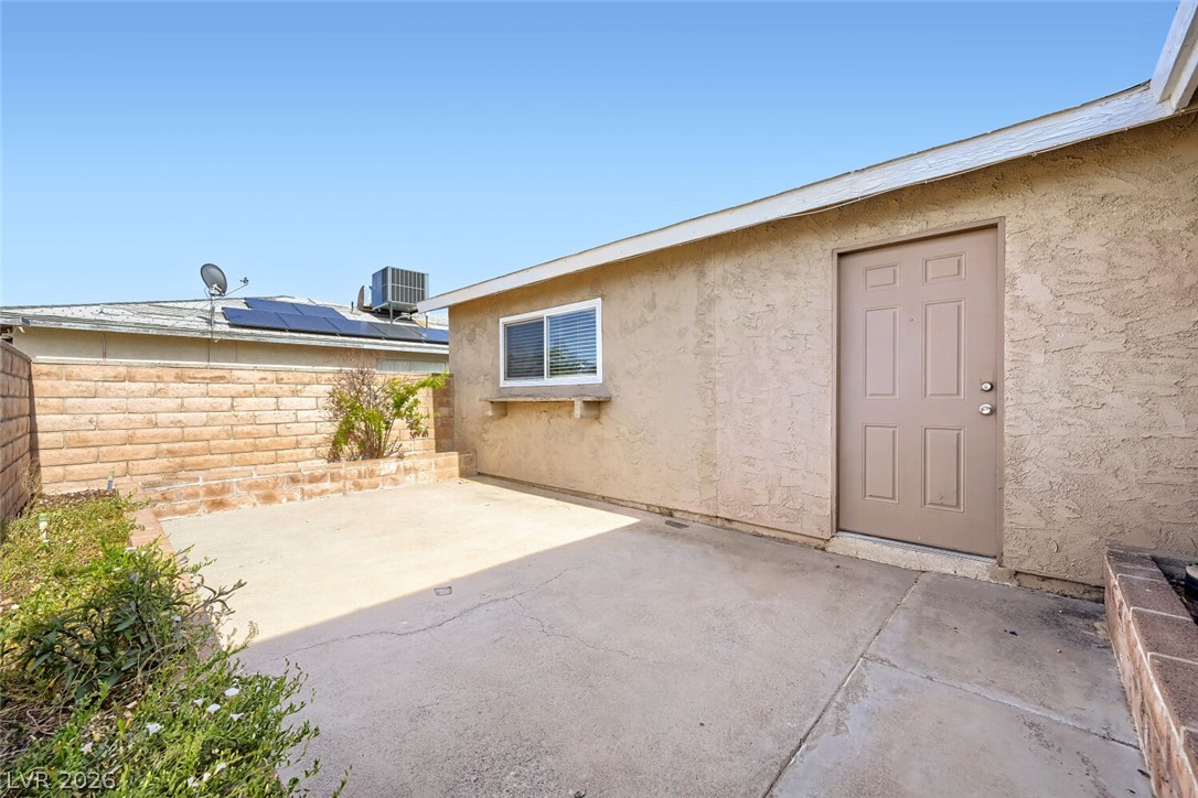 6321 Portola Road Las Vegas, NV 89108 - Photo 19 of 29 A well-maintained side yard offers a private patio area, ideal for relaxed outdoor living.