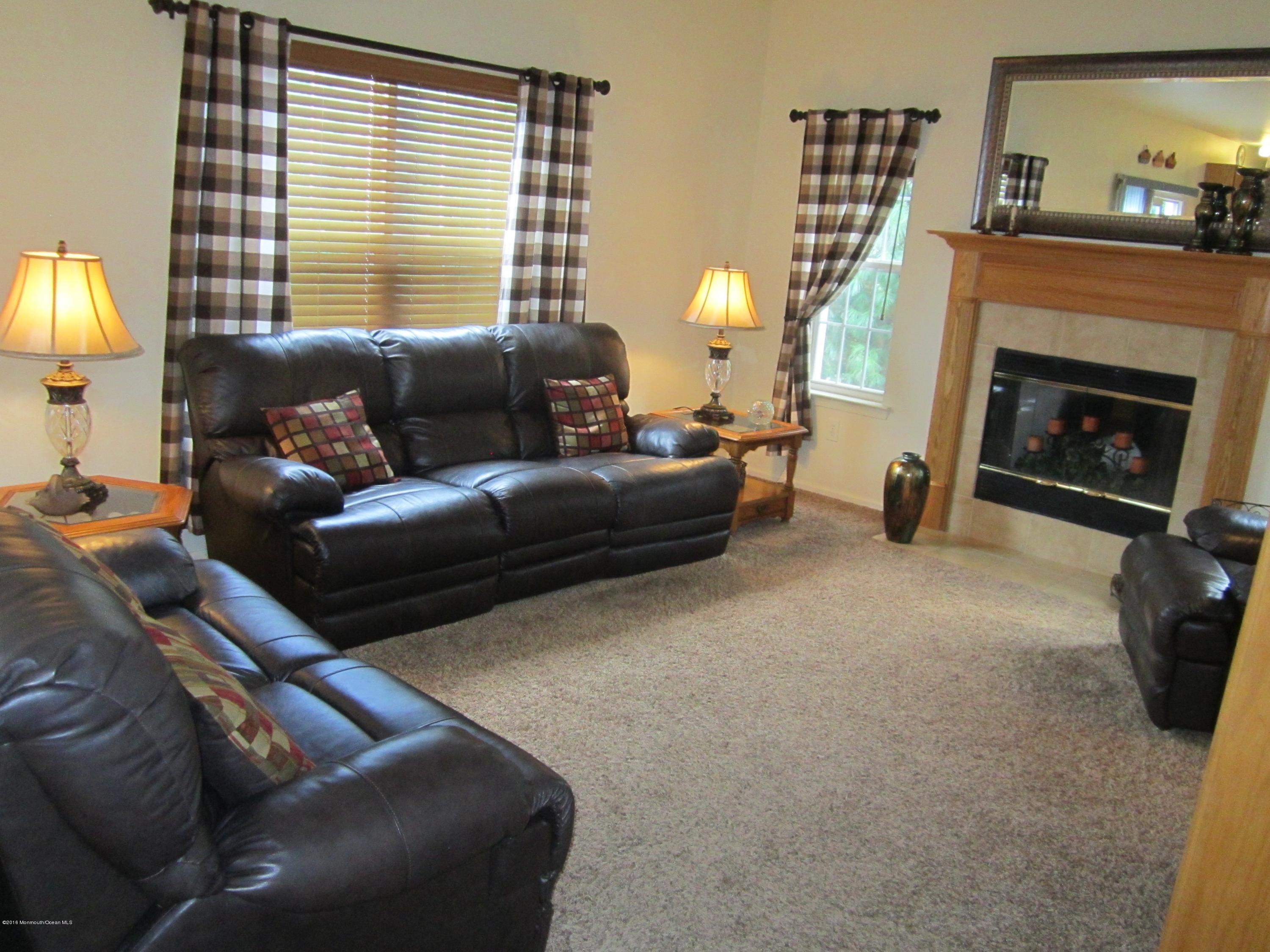 103 Valley Road Jackson, NJ 08527 - Photo 11 of 31 a living room with furniture and a fireplace