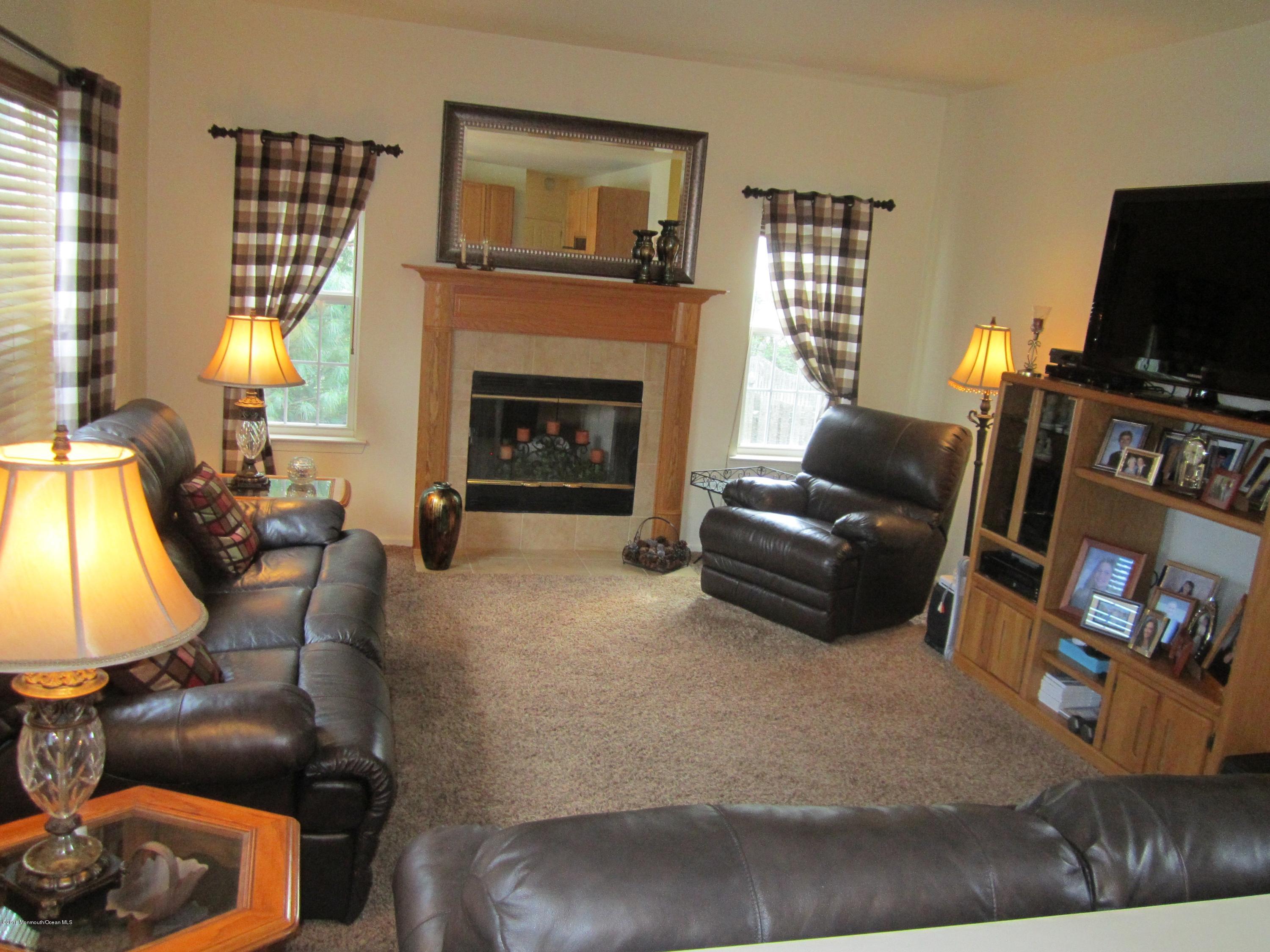 103 Valley Road Jackson, NJ 08527 - Photo 12 of 31 a living room with furniture and a fireplace