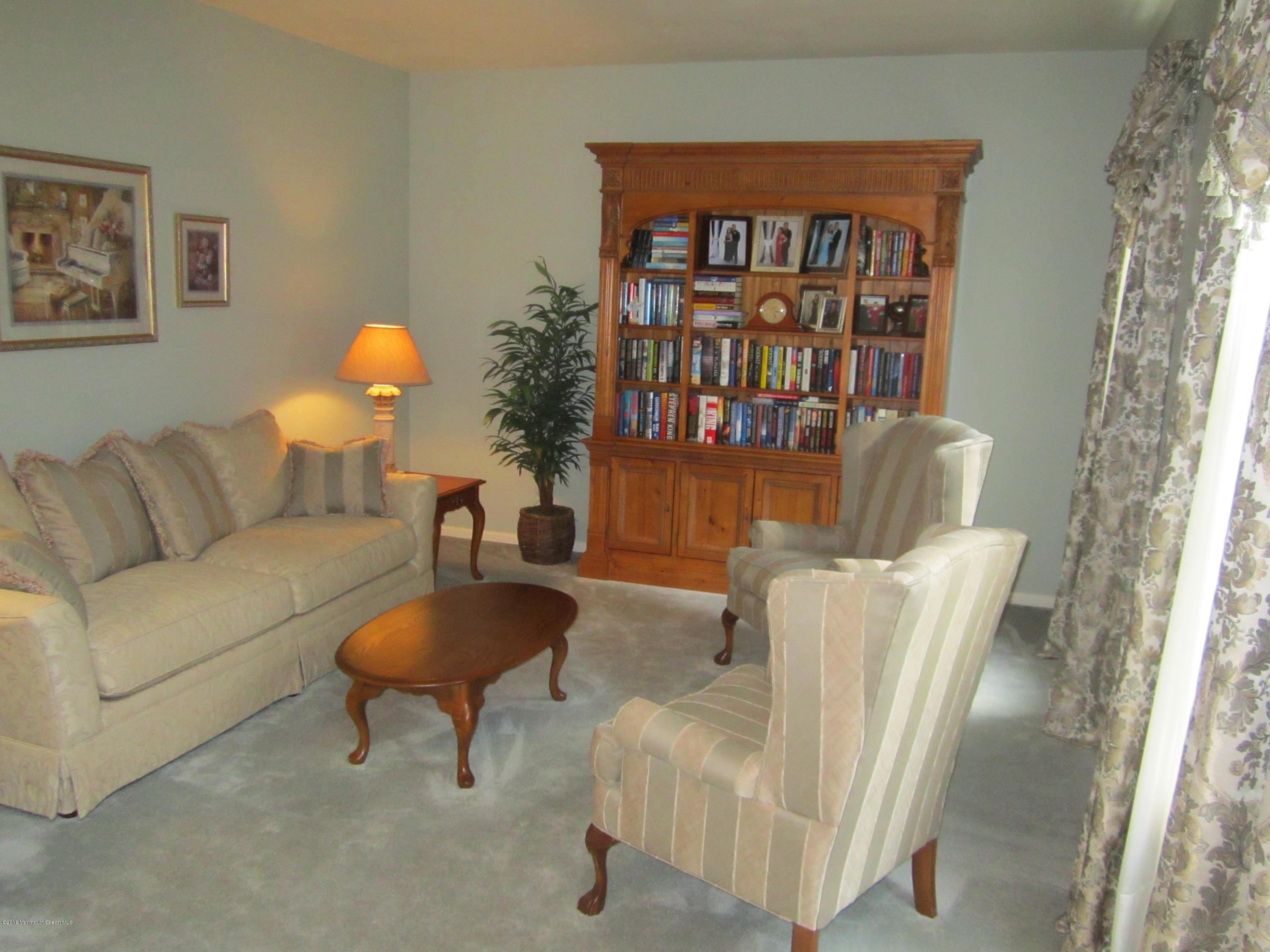 103 Valley Road Jackson, NJ 08527 - Photo 4 of 31 a living room with furniture and a book shelf