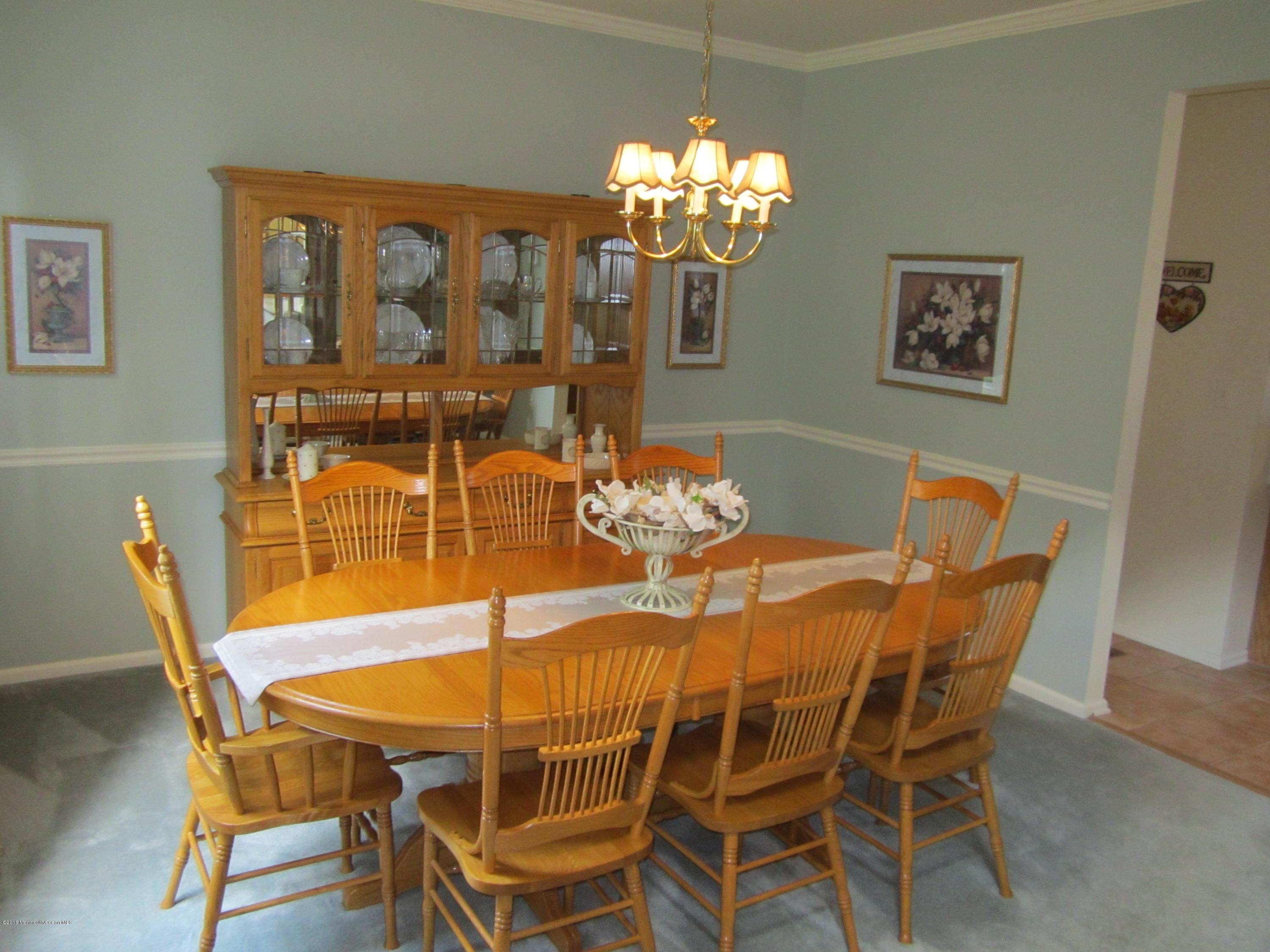 103 Valley Road Jackson, NJ 08527 - Photo 6 of 31 a dining room with furniture a chandelier and wooden floor