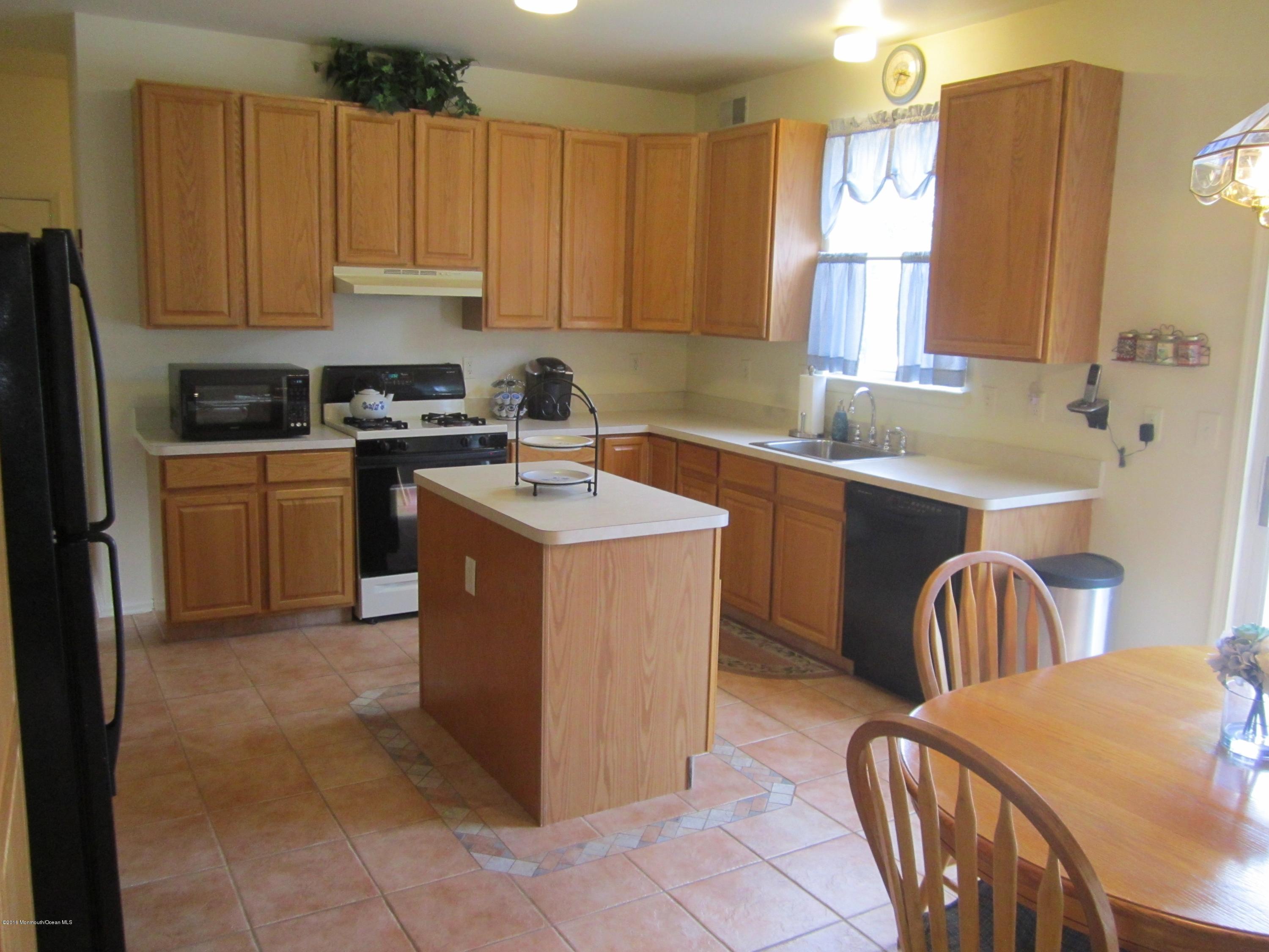 103 Valley Road Jackson, NJ 08527 - Photo 7 of 31 a kitchen with a sink stove and cabinets