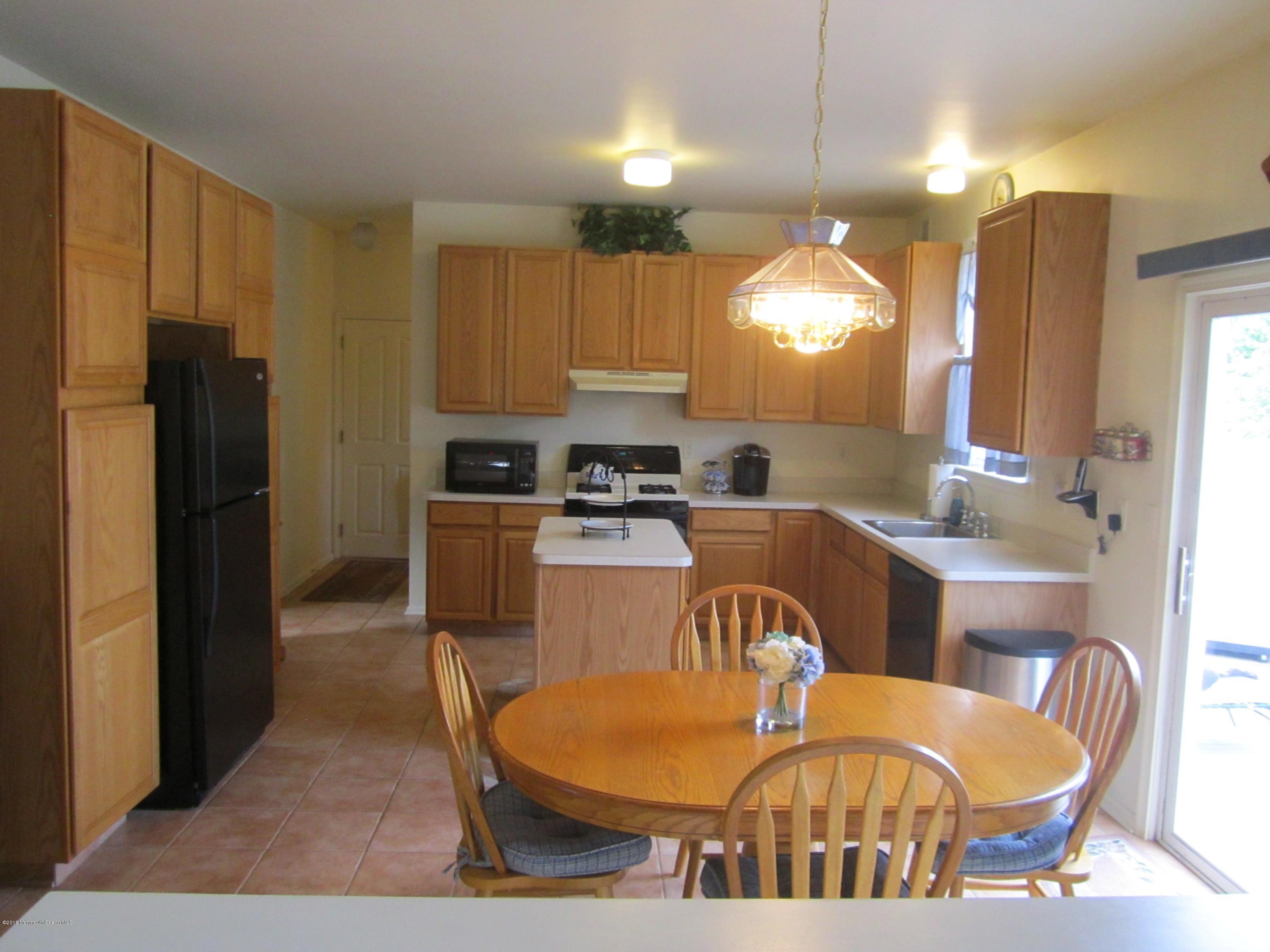 103 Valley Road Jackson, NJ 08527 - Photo 8 of 31 a kitchen with granite countertop a refrigerator a stove a sink dishwasher with a dining table and chairs