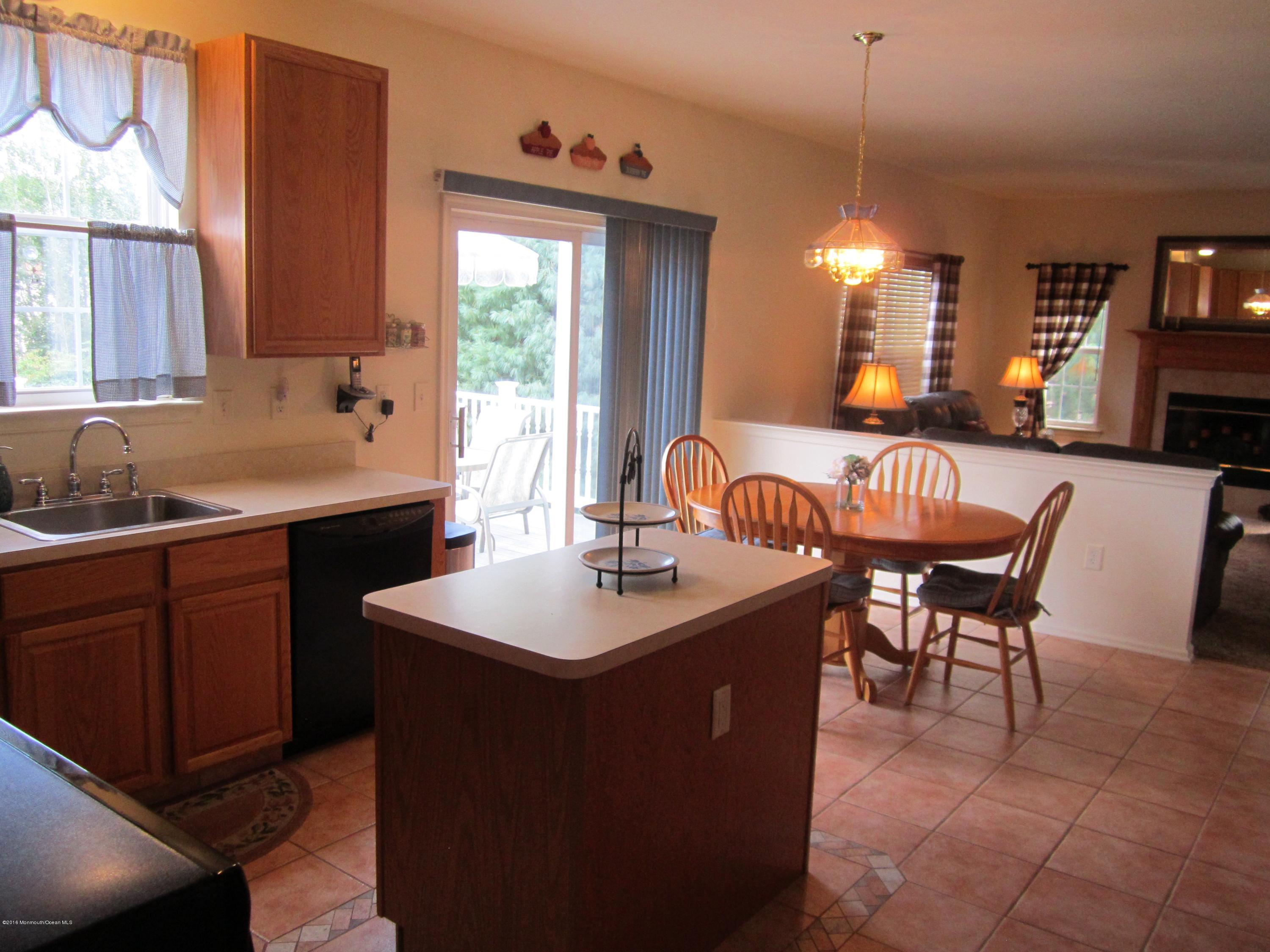 103 Valley Road Jackson, NJ 08527 - Photo 9 of 31 a kitchen with a sink a counter top space and living room view