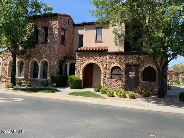 a front view of a house with yard and trees