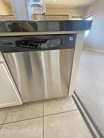 a kitchen with metallic refrigerator freezer and a dishwasher