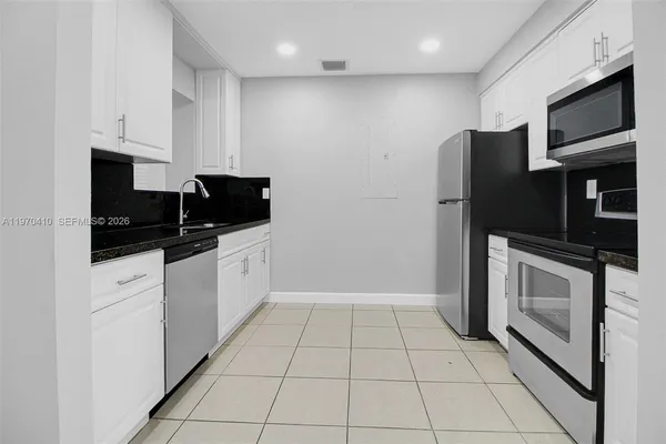 a kitchen with stainless steel appliances a refrigerator stove microwave and cabinets