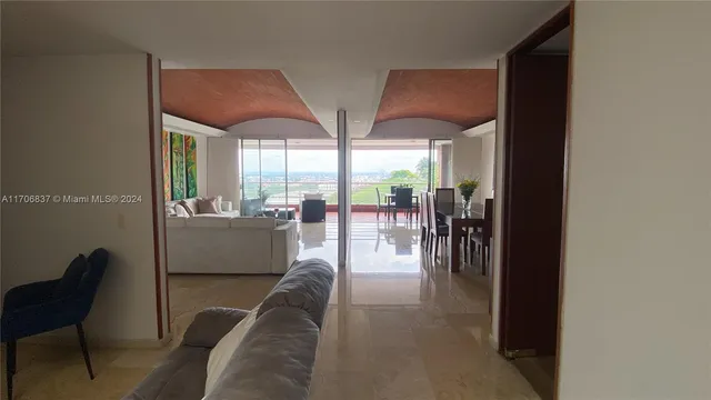 a living room with couches and balcony view
