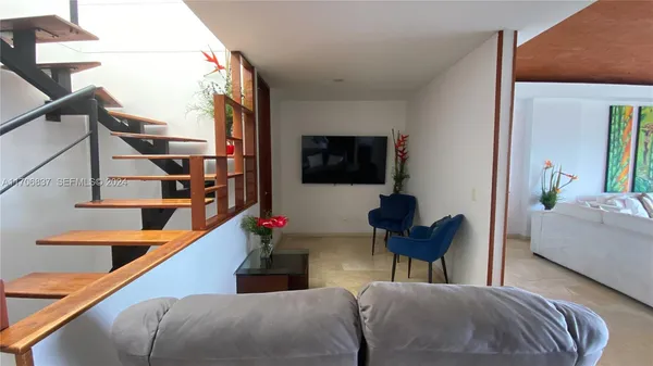 a bedroom with furniture and a large window