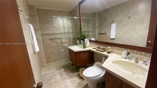 a bathroom with a sink toilet and shower