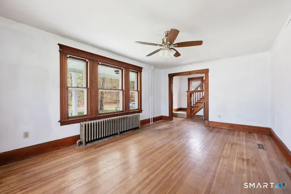 wooden floor in an empty room with a window