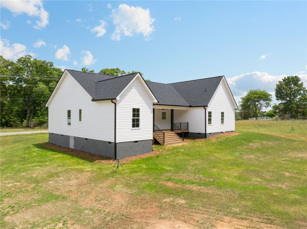 1735 Maw Bridge Road Central, SC 29630 - Photo 30 of 38 This newly constructed residence offers a modern facade with pristine siding, set against a backdrop of natural beauty.
