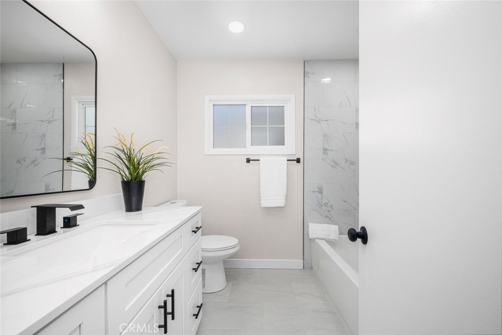 3819 North Studebaker Road Long Beach, CA 90808 - Photo 21 of 62 Beautifully remodeled bathroom showcasing a luxurious, spa-like atmosphere.
