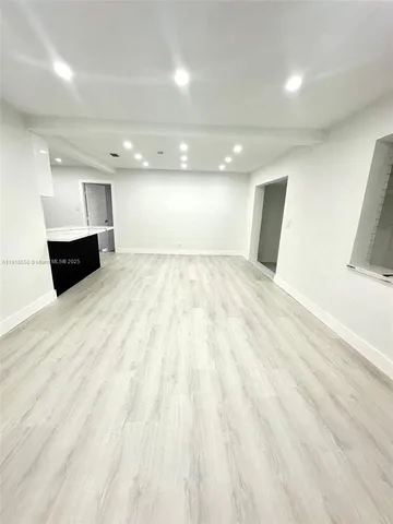 a view of an empty room and wooden floor