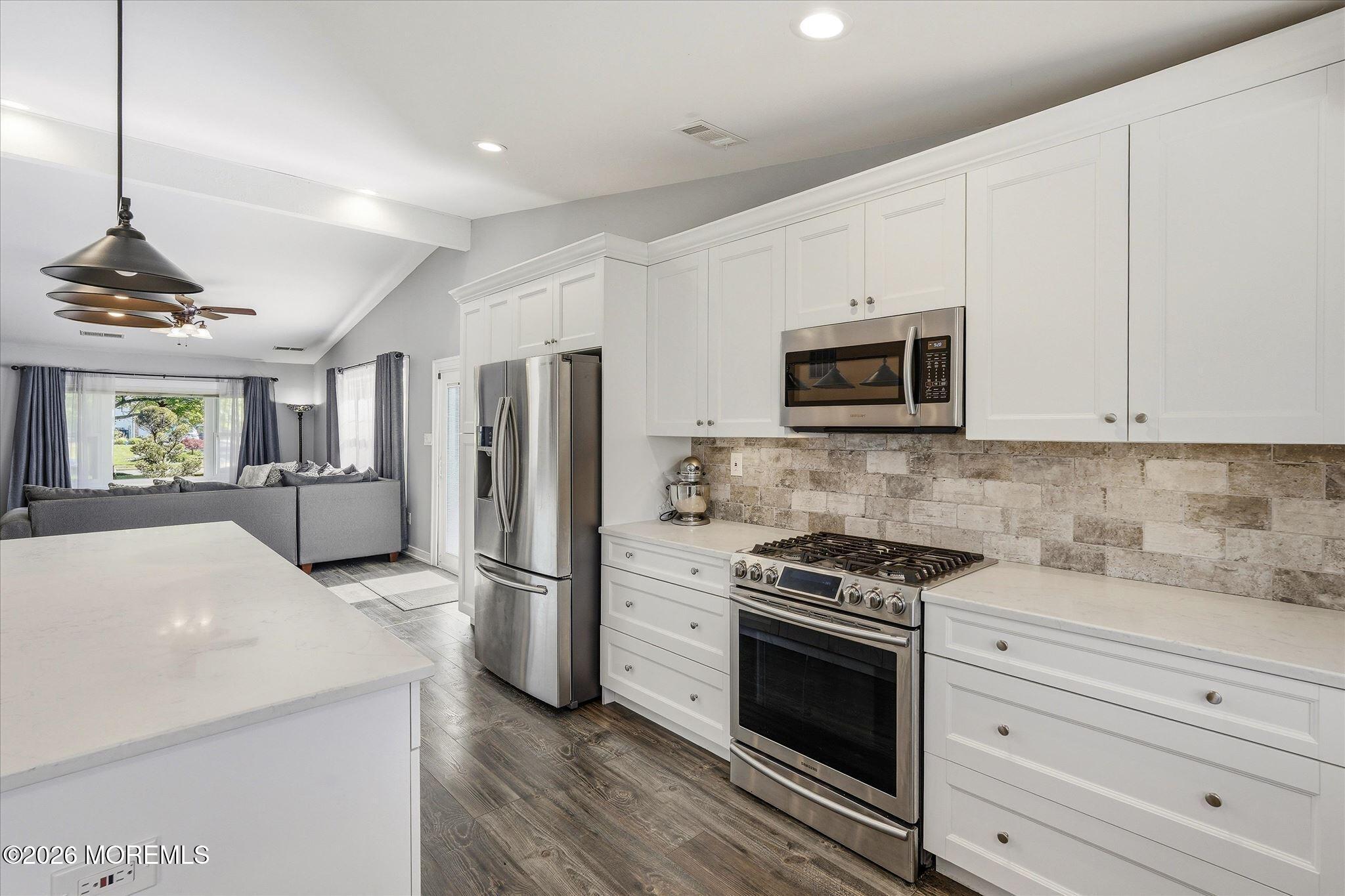 22 Ethan Allen Road Freehold, NJ 07728 - Photo 13 of 31 a kitchen with granite countertop a refrigerator stove and microwave