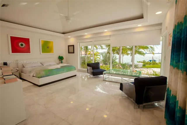 a spacious bedroom with a large bed and a large window