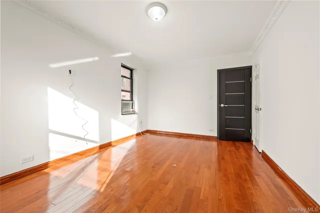 a view of an empty room and wooden floor