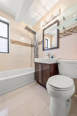 a bathroom with a toilet a sink and bathtub