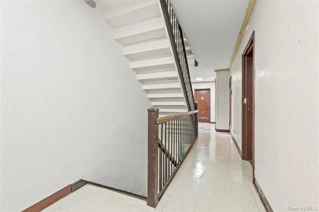 a view of staircase with white walls and a window