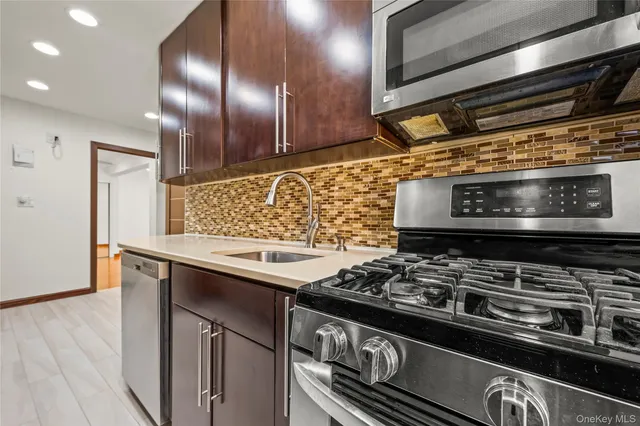 a stove top oven sitting inside of a kitchen