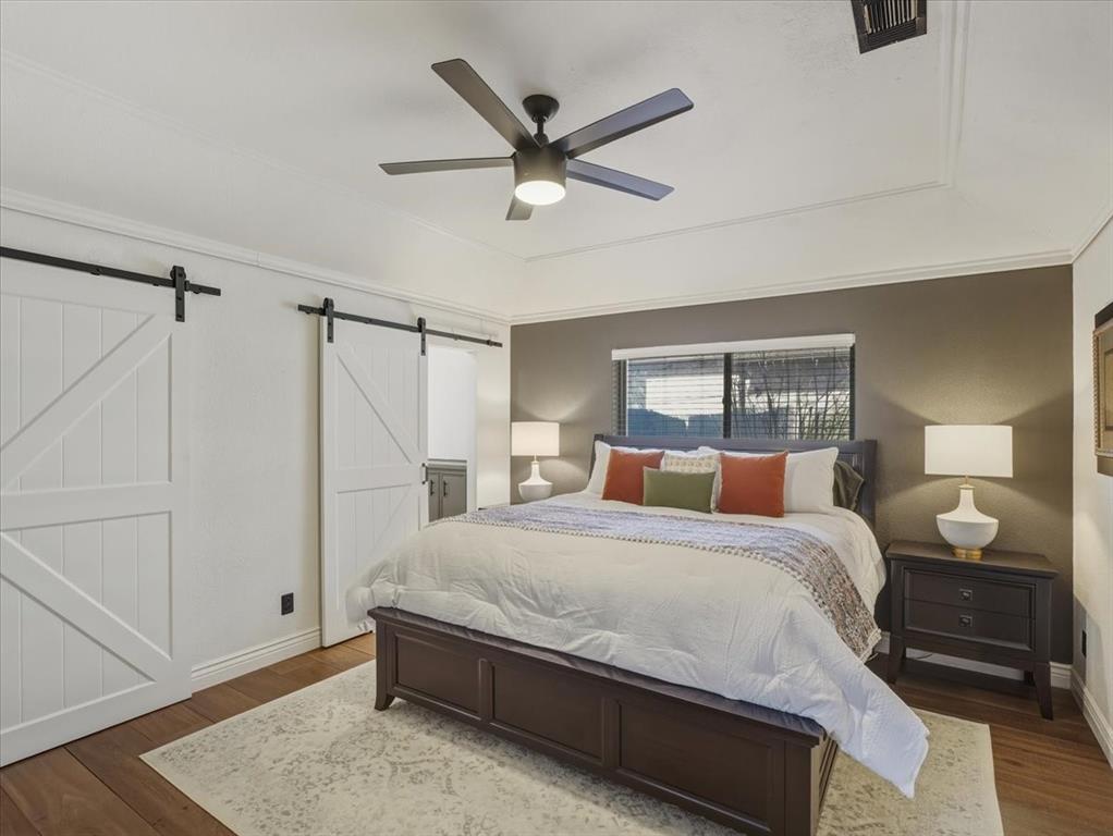 1662 Watson Road Fort Worth, TX 76103 - Photo 17 of 37 Bedroom with wood finished floors, ceiling fan, and ornamental molding
