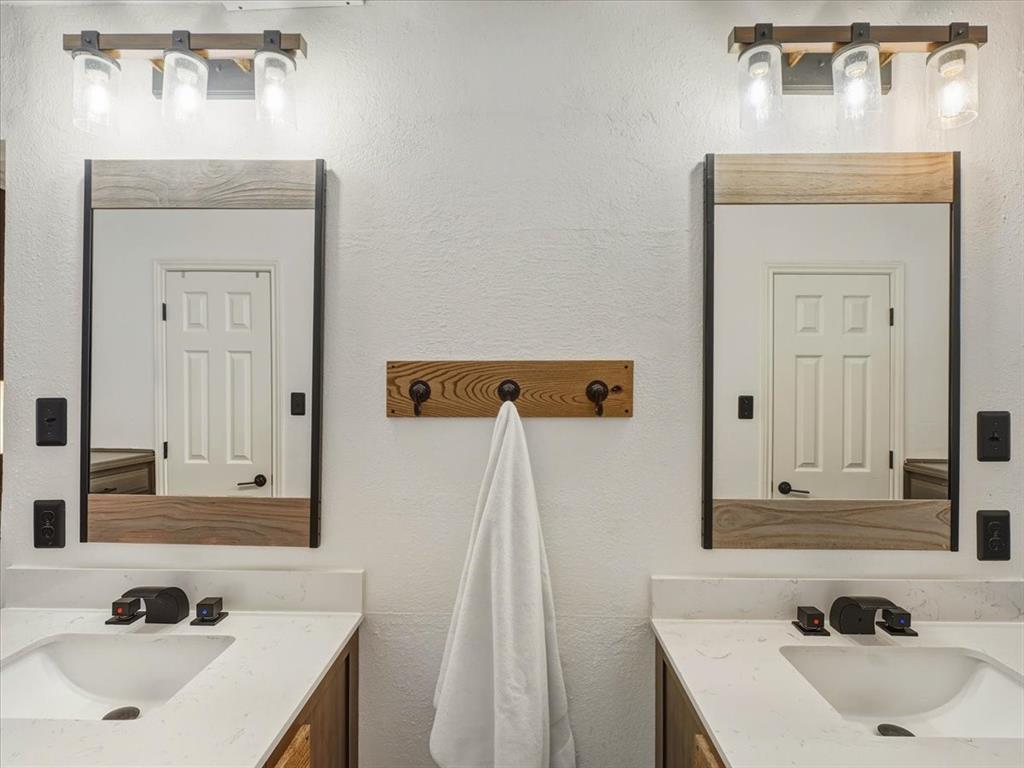 1662 Watson Road Fort Worth, TX 76103 - Photo 19 of 37 Bathroom featuring vanity and a textured wall