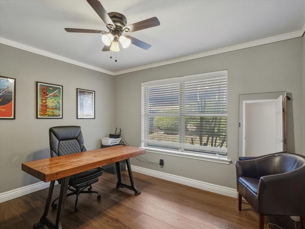1662 Watson Road Fort Worth, TX 76103 - Photo 27 of 37 Home office with dark wood finished floors, healthy amount of natural light, ornamental molding, and a ceiling fan