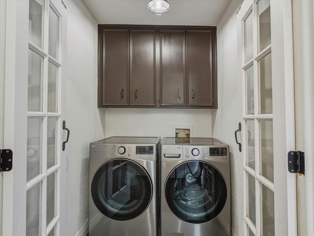 1662 Watson Road Fort Worth, TX 76103 - Photo 28 of 37 Laundry room featuring cabinet space, washing machine and dryer, and french doors
