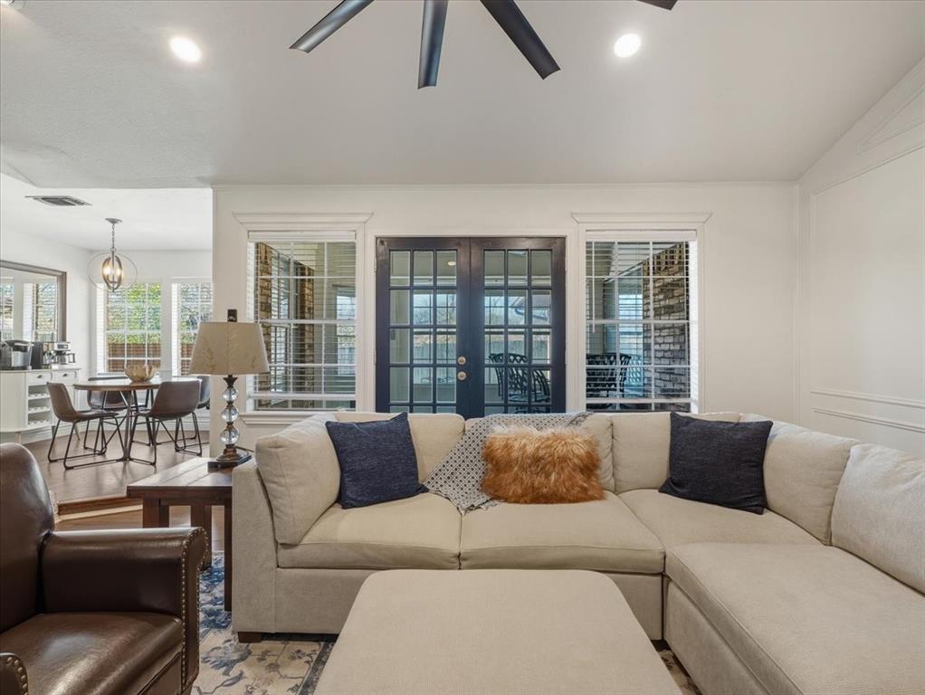 1662 Watson Road Fort Worth, TX 76103 - Photo 8 of 37 Living area featuring french doors, wood finished floors, ceiling fan, and a chandelier