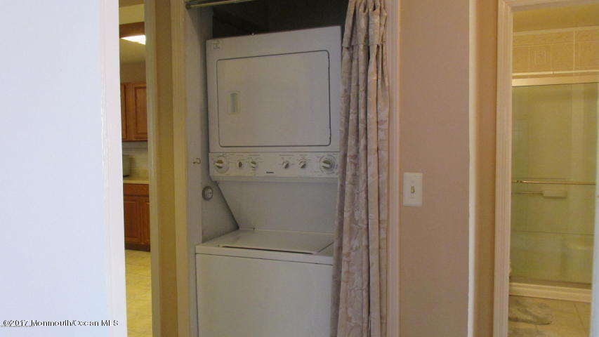 35 A Zacatin Road, Unit 1000 Freehold, NJ 07728 - Photo 13 of 16 a utility room with dryer and washer