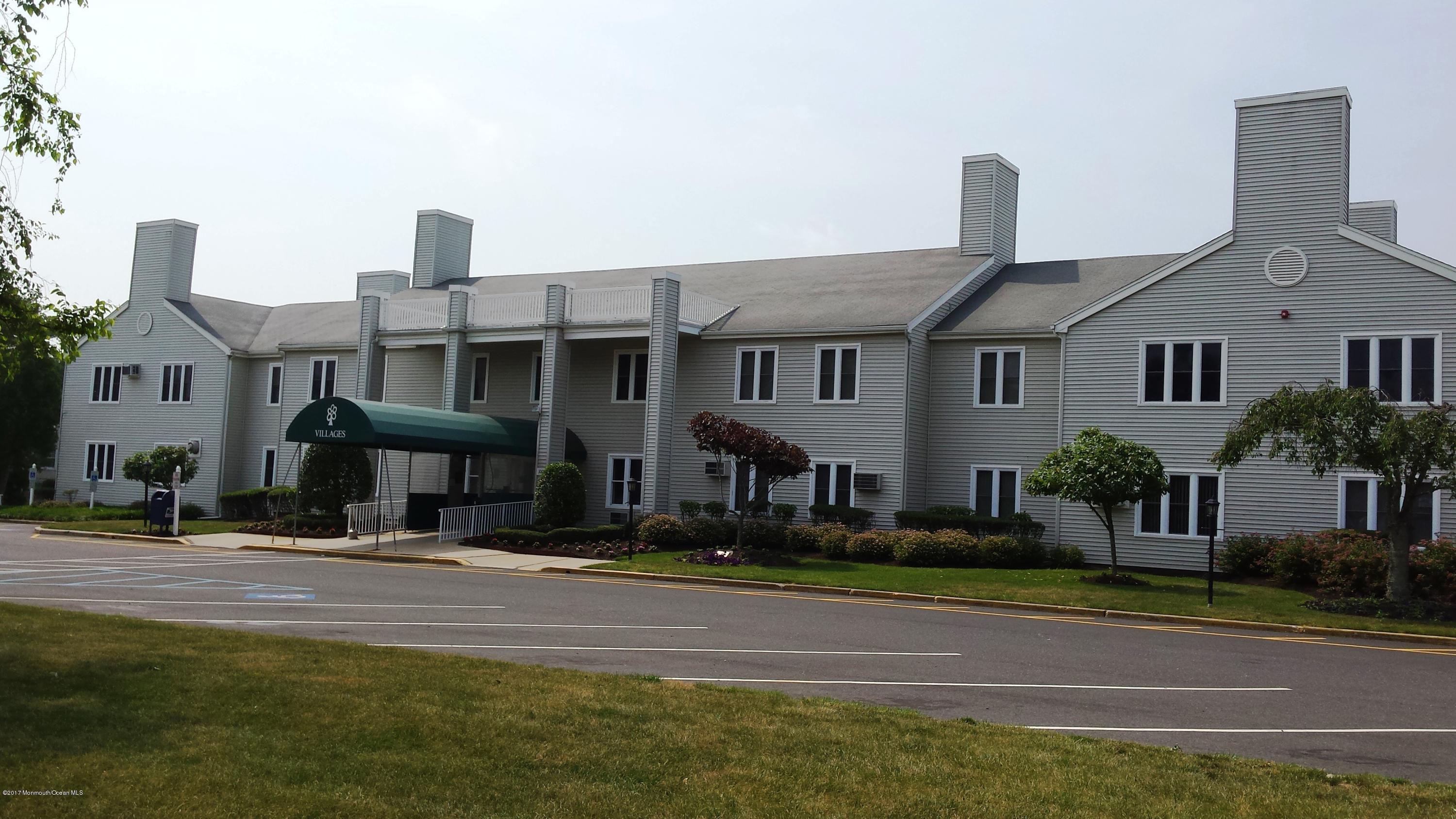 35 A Zacatin Road, Unit 1000 Freehold, NJ 07728 - Photo 14 of 16 a front view of a building with street view