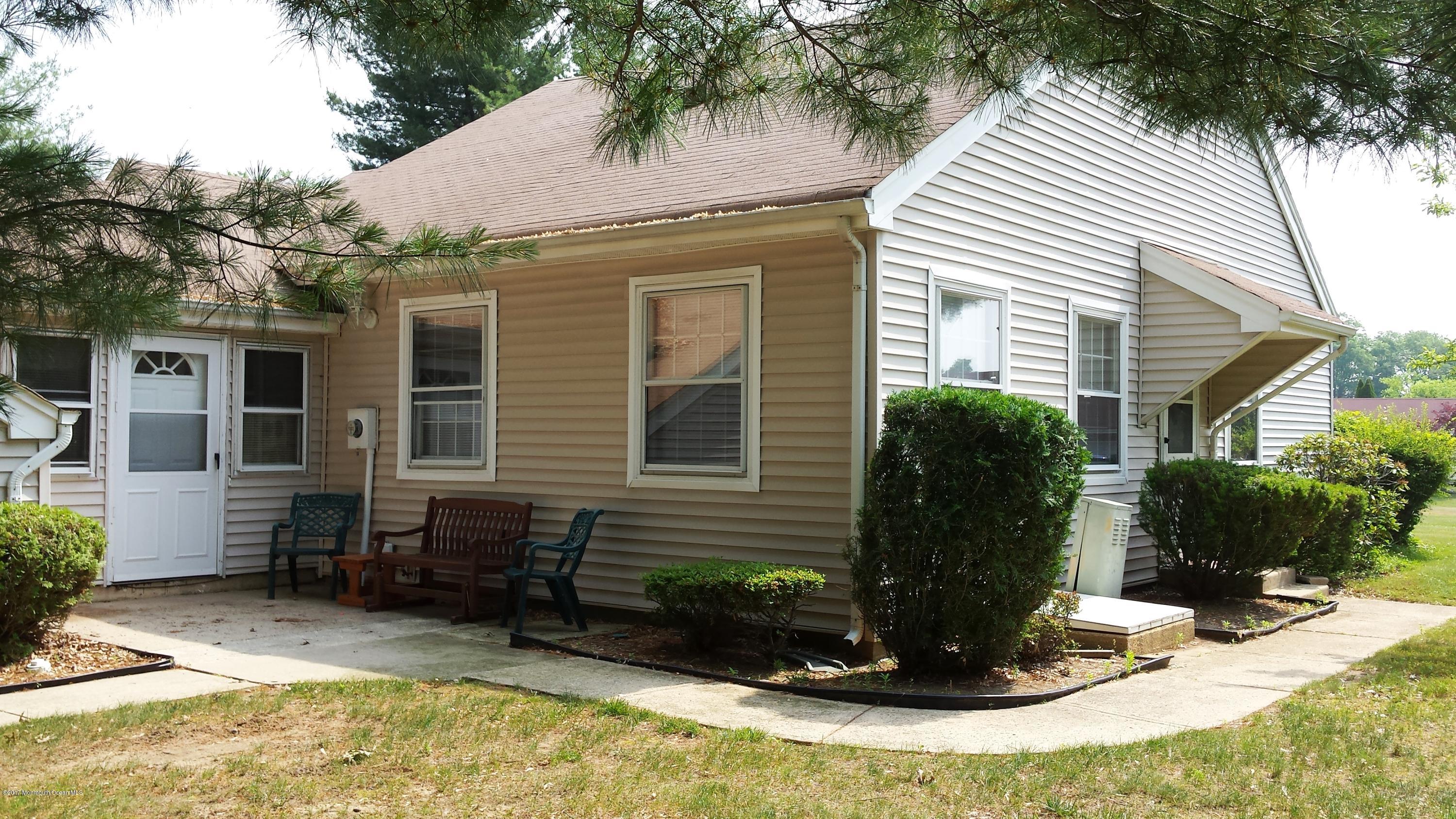 35 A Zacatin Road, Unit 1000 Freehold, NJ 07728 - Photo 2 of 16 a view of a house with a yard and sitting area