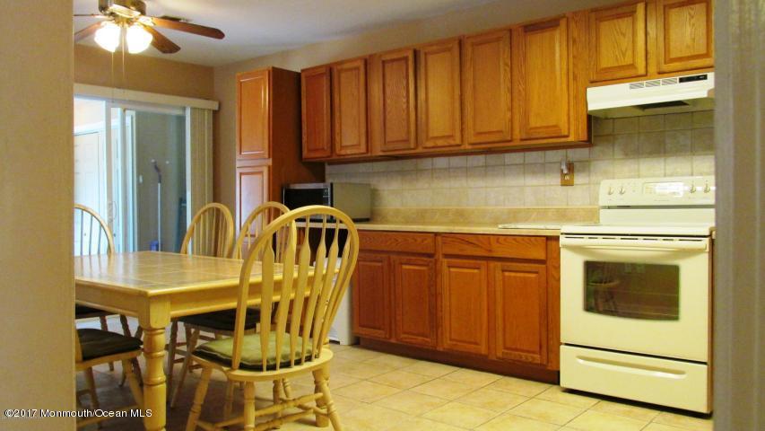 35 A Zacatin Road, Unit 1000 Freehold, NJ 07728 - Photo 5 of 16 a kitchen with stainless steel appliances granite countertop a stove a sink and dishwasher