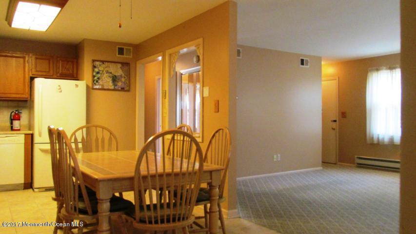 35 A Zacatin Road, Unit 1000 Freehold, NJ 07728 - Photo 6 of 16 a view of a dining area with furniture and a window
