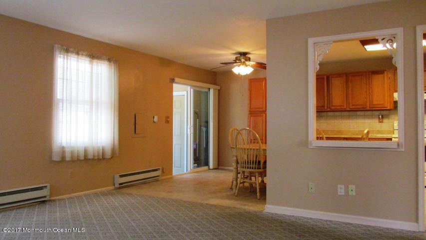 35 A Zacatin Road, Unit 1000 Freehold, NJ 07728 - Photo 7 of 16 wooden floor and windows in a room