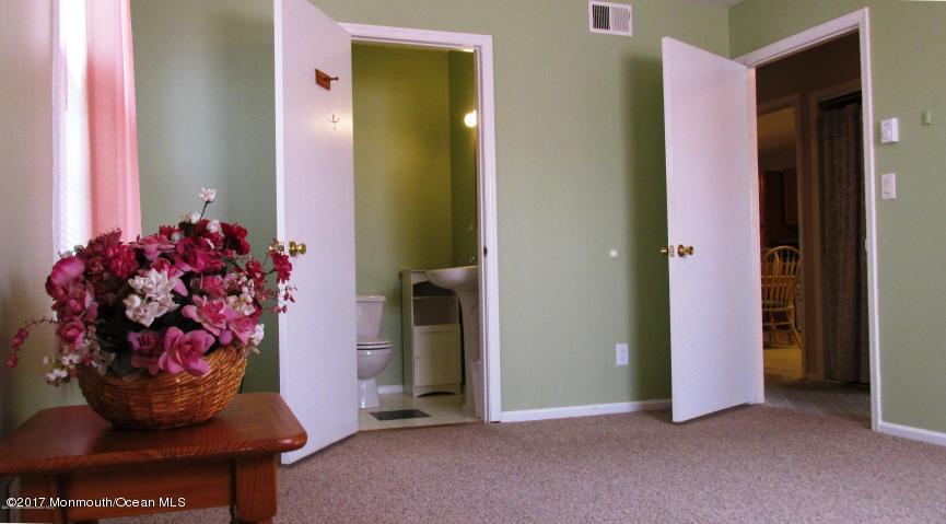 35 A Zacatin Road, Unit 1000 Freehold, NJ 07728 - Photo 9 of 16 a view of a entryway with flower pots