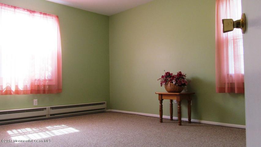 35 A Zacatin Road, Unit 1000 Freehold, NJ 07728 - Photo 10 of 16 a room with a window and a table