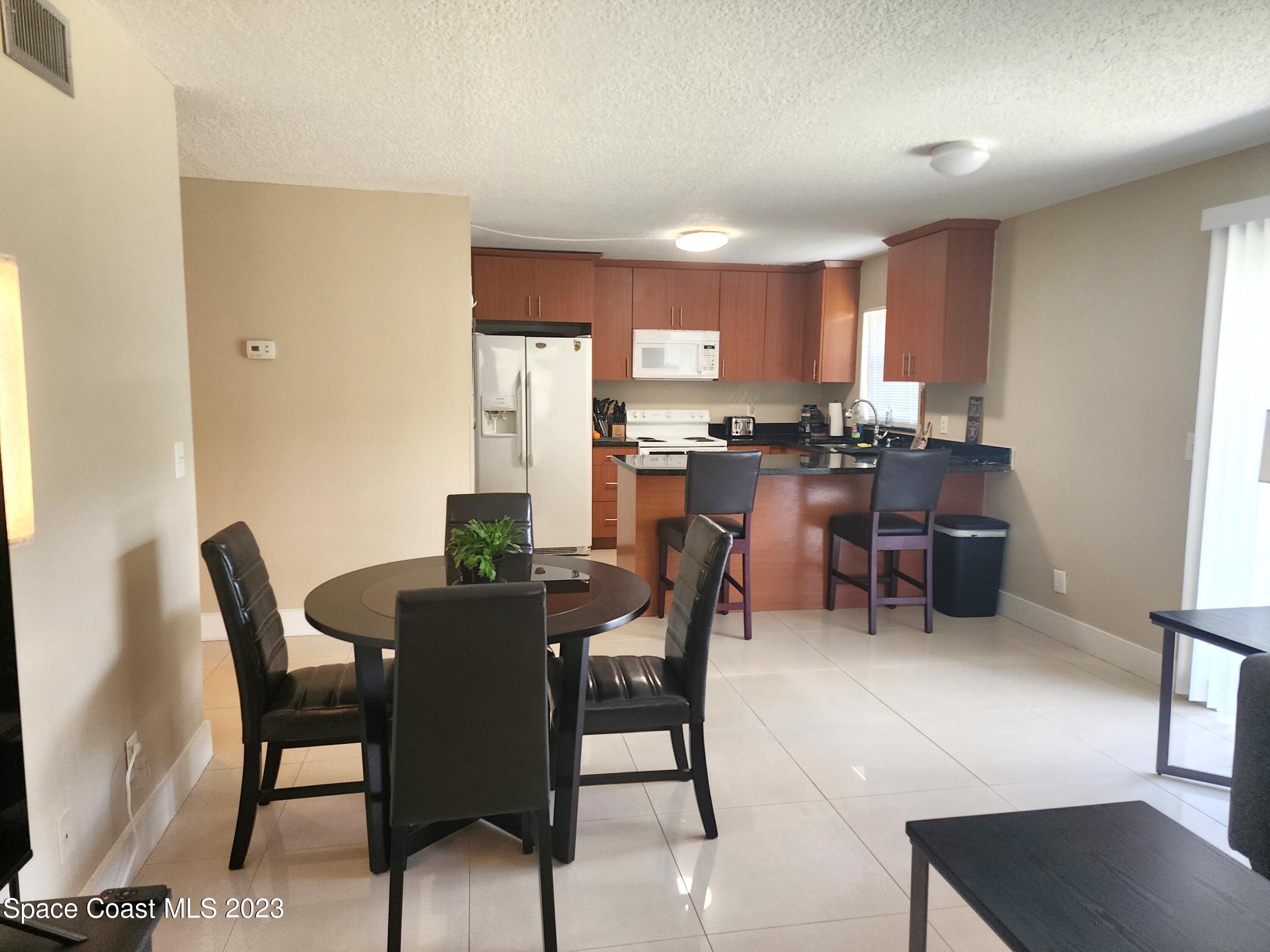 582 North Wickham Road, Unit 89 Melbourne, FL 32934 - Photo 4 of 25 a view of a dining room with furniture