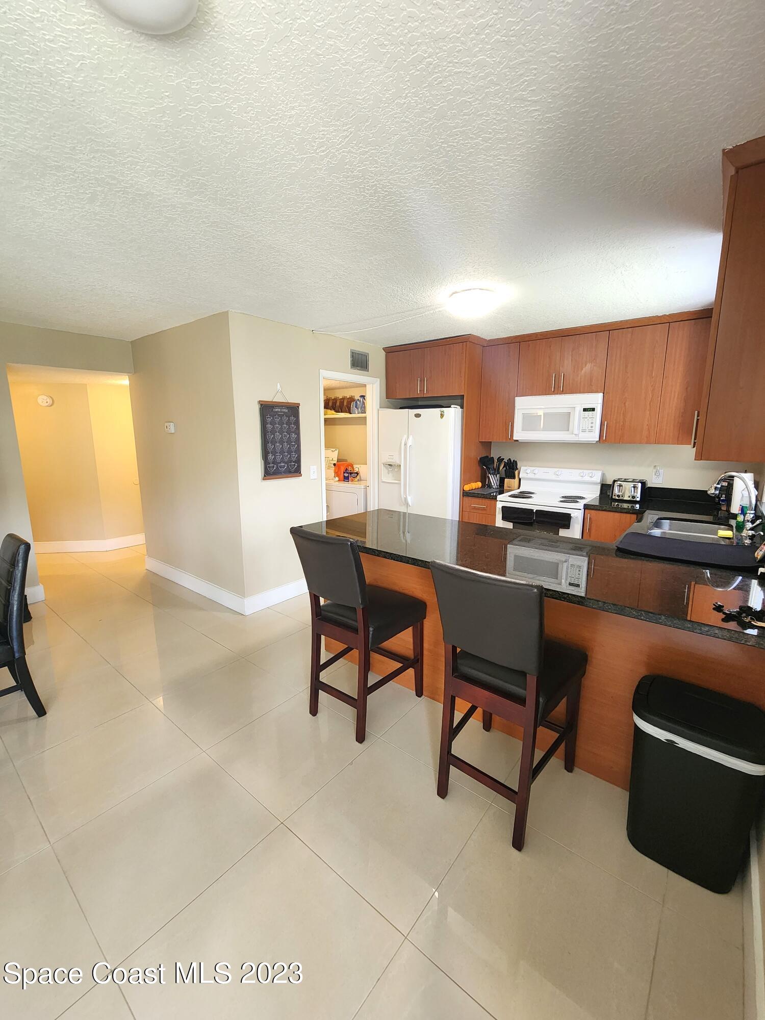 582 North Wickham Road, Unit 89 Melbourne, FL 32934 - Photo 5 of 25 a workspace with furniture and a window