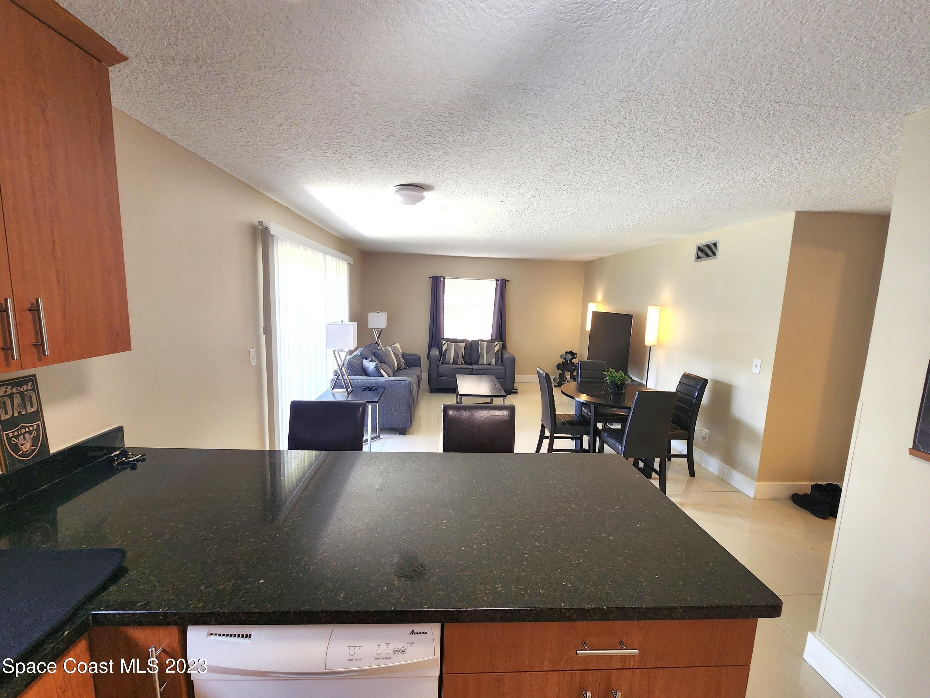 582 North Wickham Road, Unit 89 Melbourne, FL 32934 - Photo 6 of 25 a living room with furniture window and wooden floor