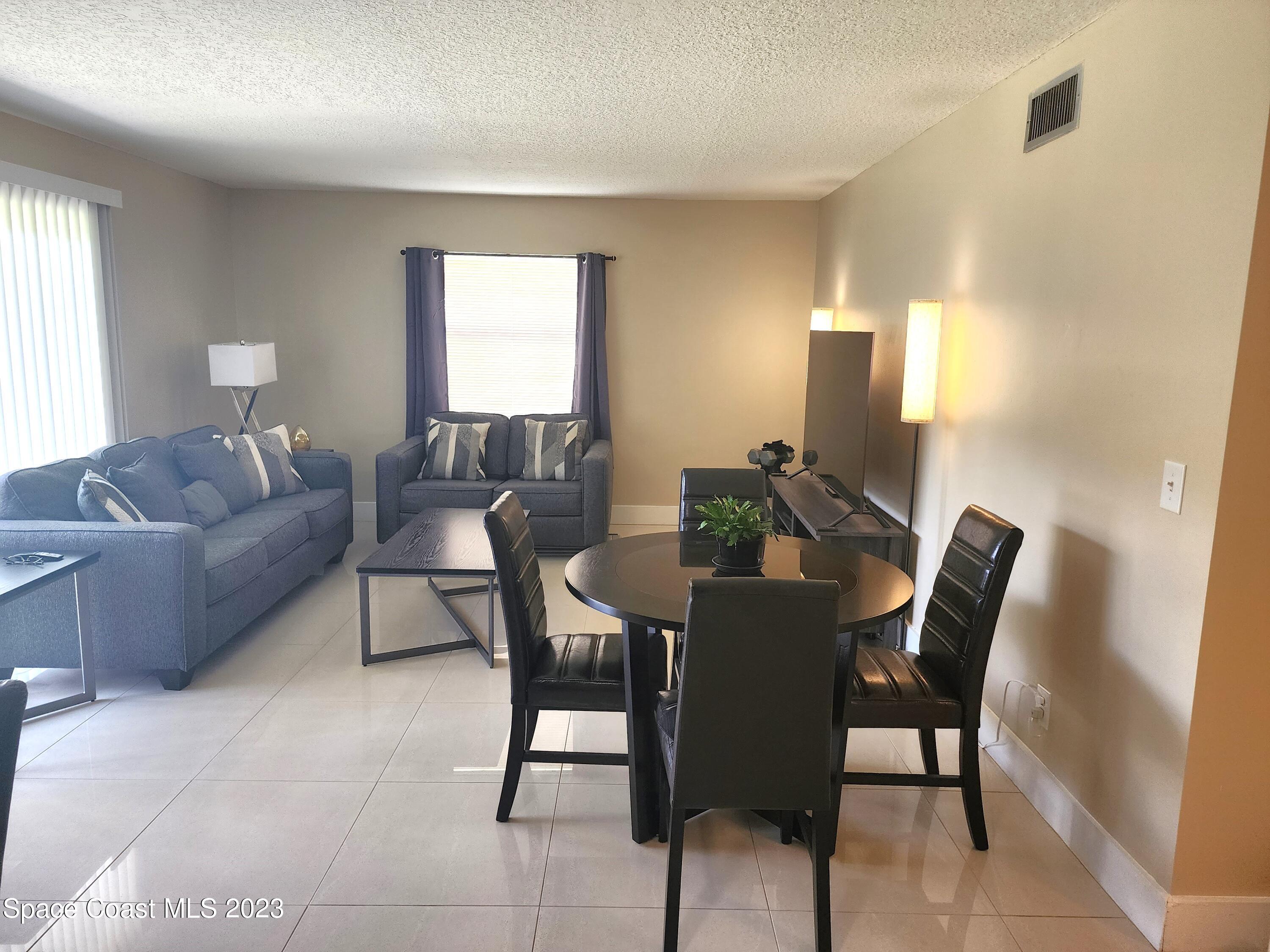582 North Wickham Road, Unit 89 Melbourne, FL 32934 - Photo 7 of 25 a view of a dining room with furniture